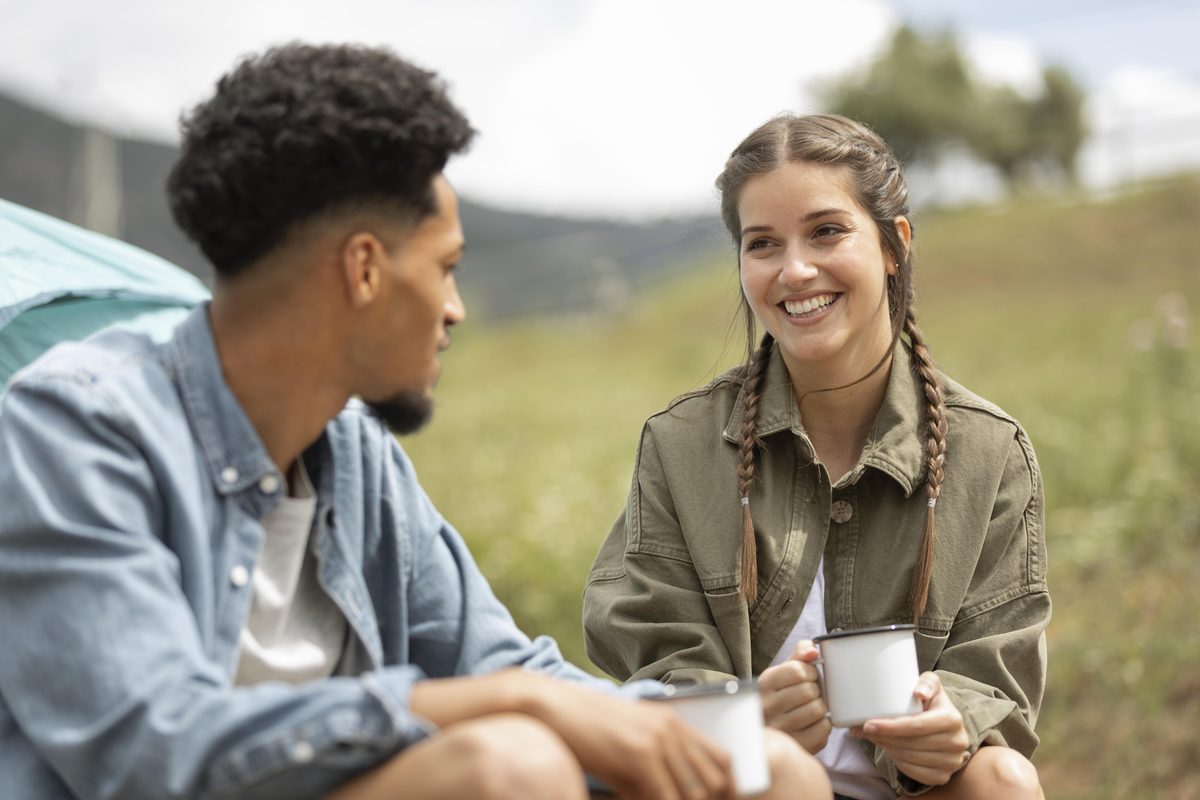 Young couple talking together outdoors over coffee