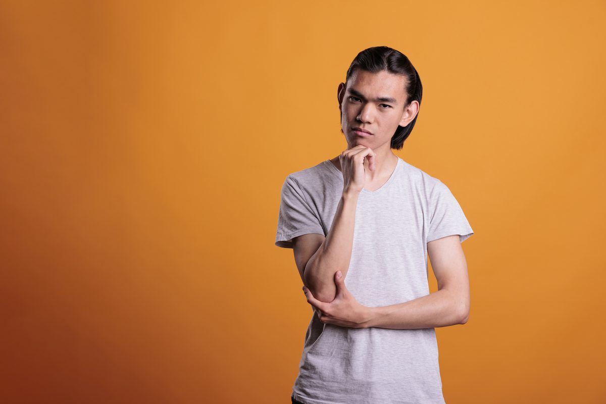 A young person looking thoughtful, considering the difference between two STIs