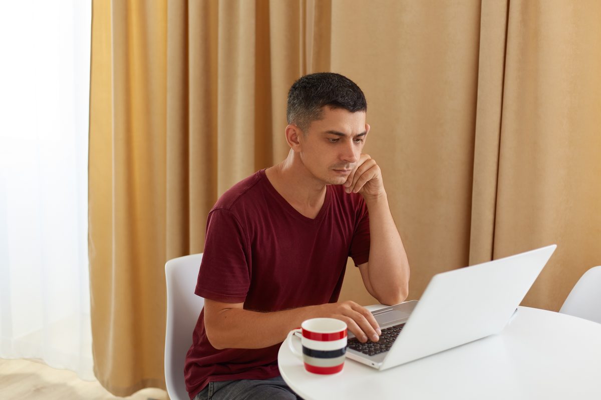 A person reading about sexual health on a laptop at home