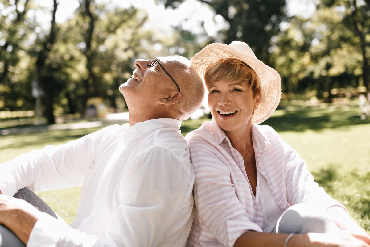 An older couple together outdoors, smiling
