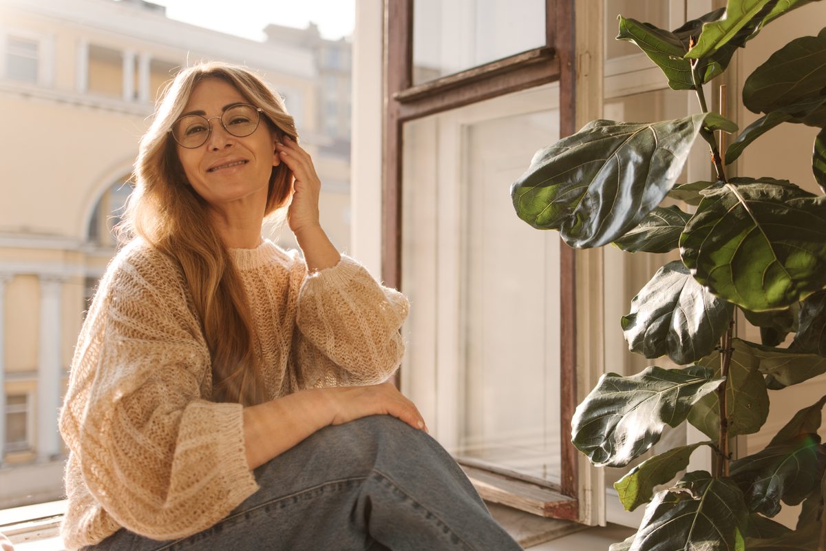 A woman looking thoughtful at home, reading about sexual health